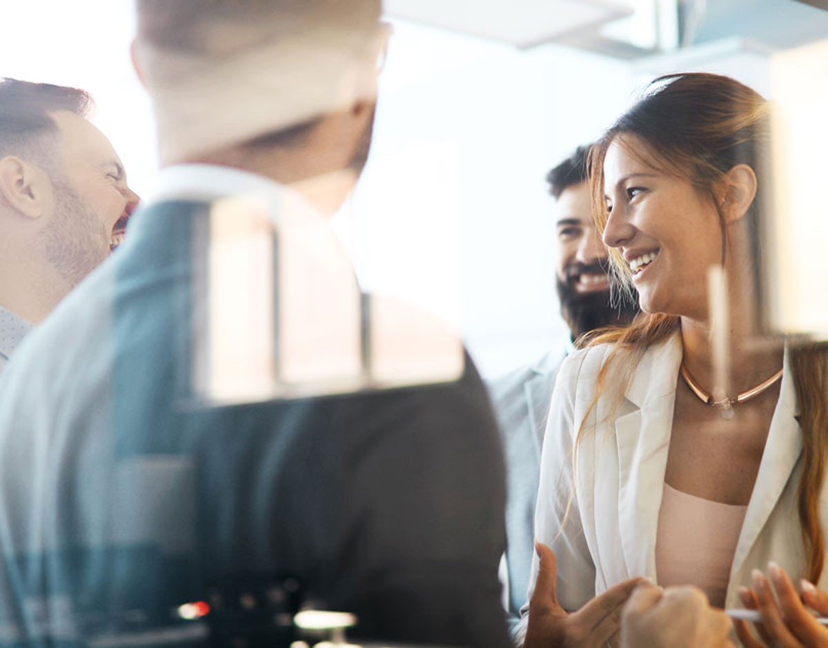 people in an office speaking together about investments